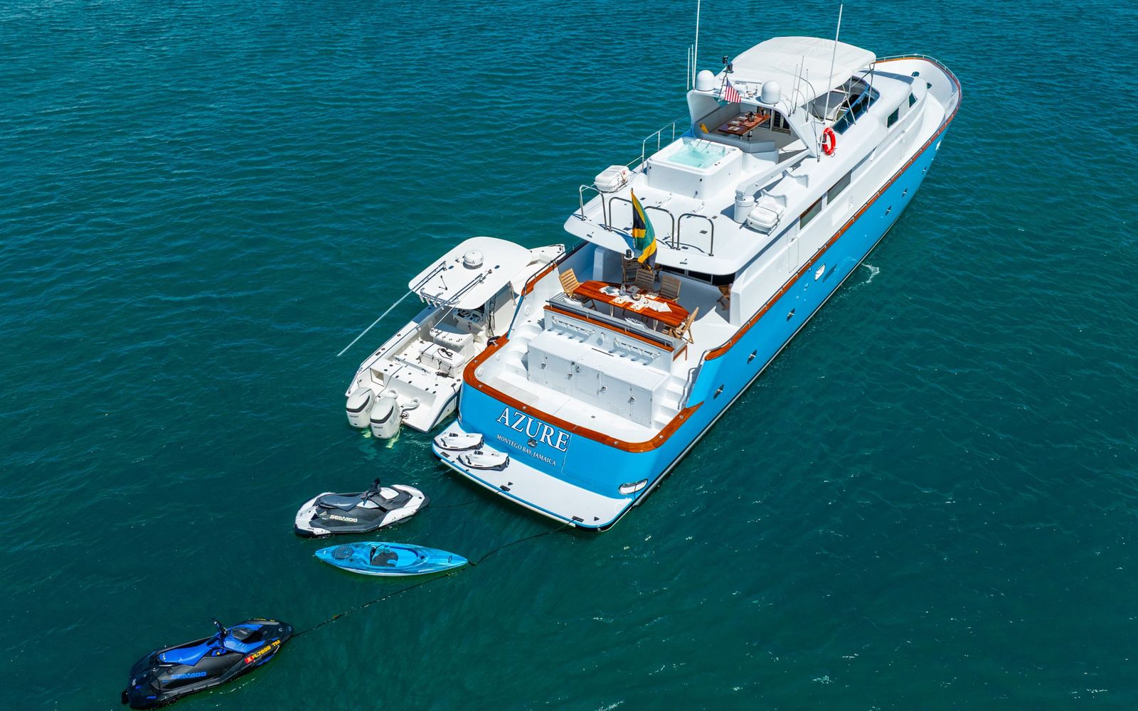 Yacht Azure at anchor with its tender, jet skis and kayak