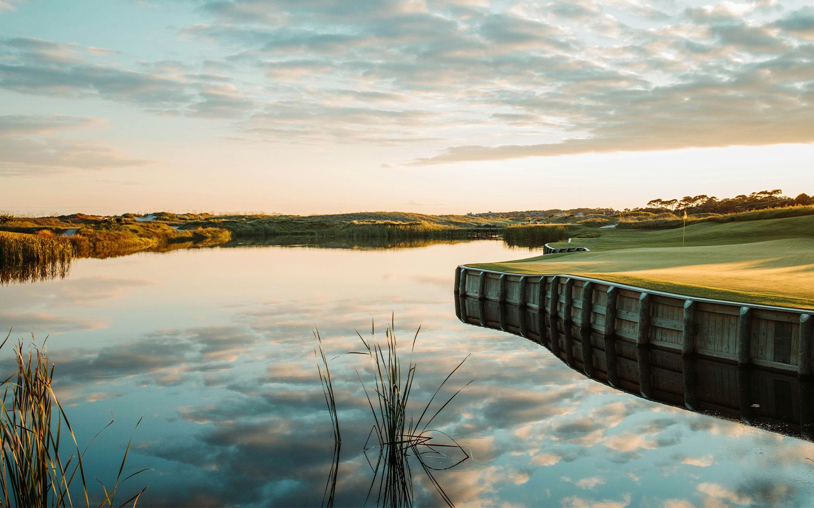 Kiawah Island golf green over a marsh pond at sunrise