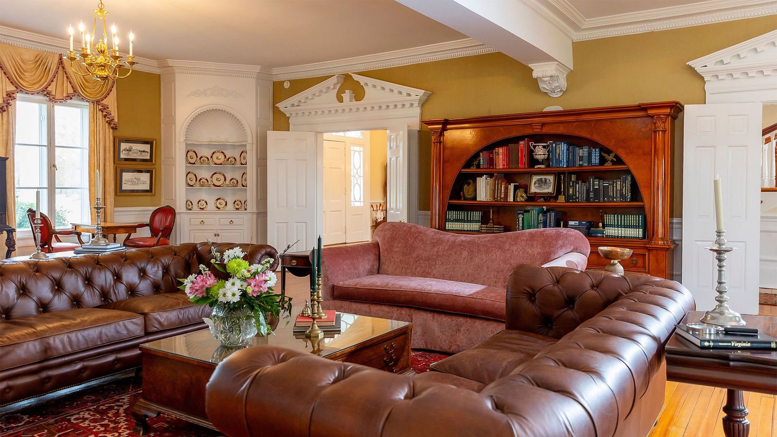 Parlor with leather Chesterfield sofas and library shelves